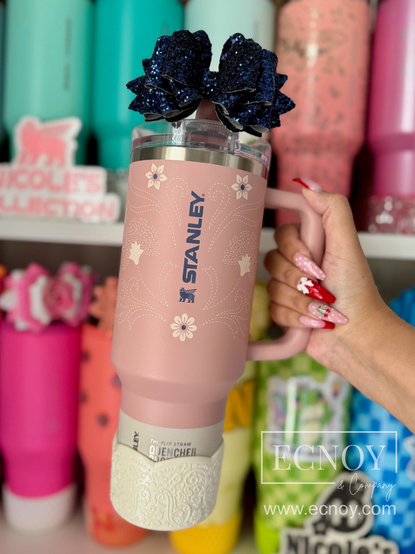 Aalijah Shimmer boot from the Ecnoy LUXE Collection — cream shimmer finish, scalloped edge, vintage-inspired floral embossed pattern — pictured on a Stanley 40oz Quencher H2.0 FlowState Tumbler in the limited edition Pink Dusk Stitch colorway.
