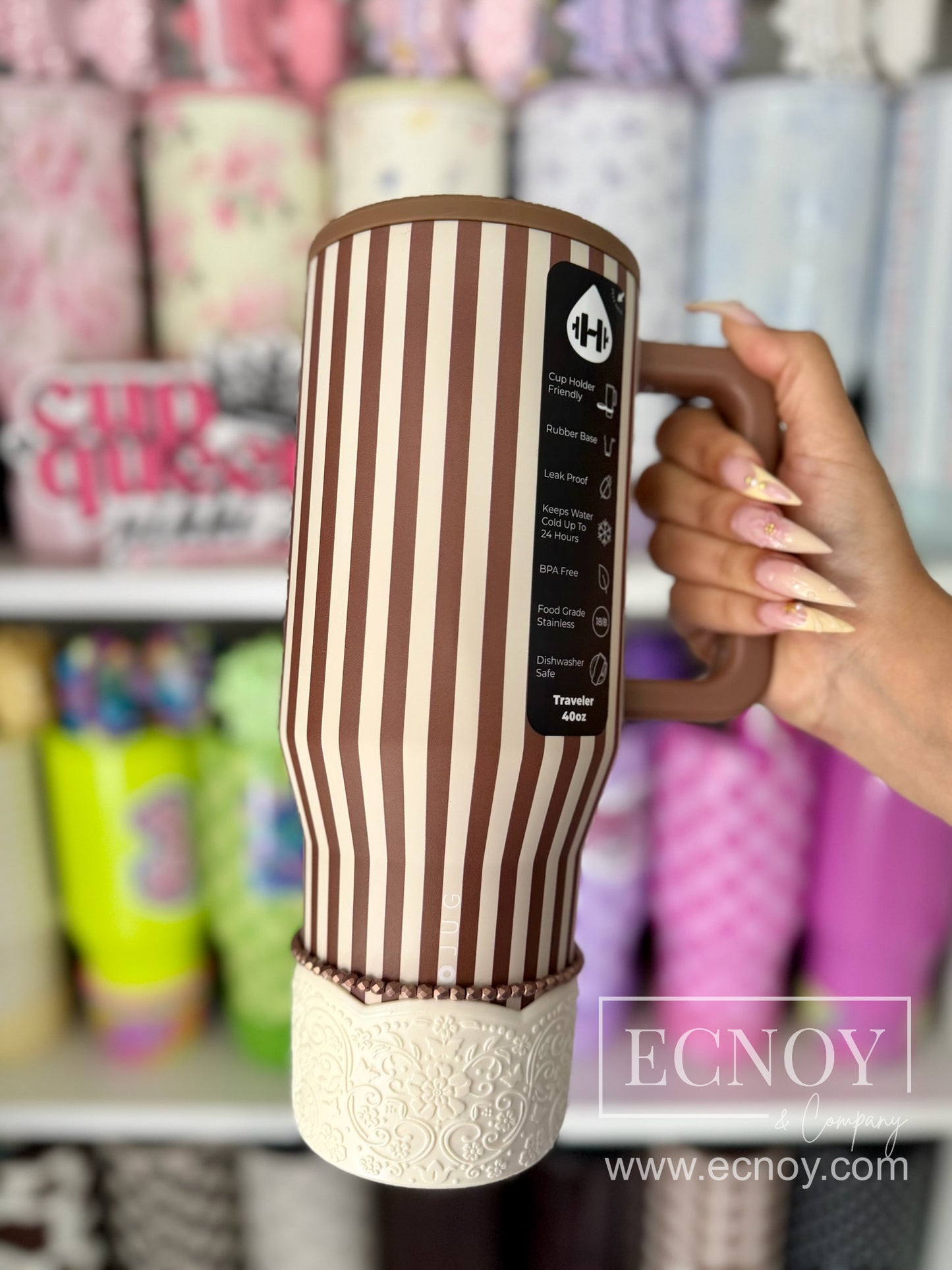 Aalijah Shimmer boot from the Ecnoy LUXE Collection — cream shimmer finish, scalloped edge, vintage-inspired floral embossed pattern — pictured on a HydroJug x Anthropologie 40oz Traveler tumbler in the Daily Practice brown-and-cream vertical stripe design.