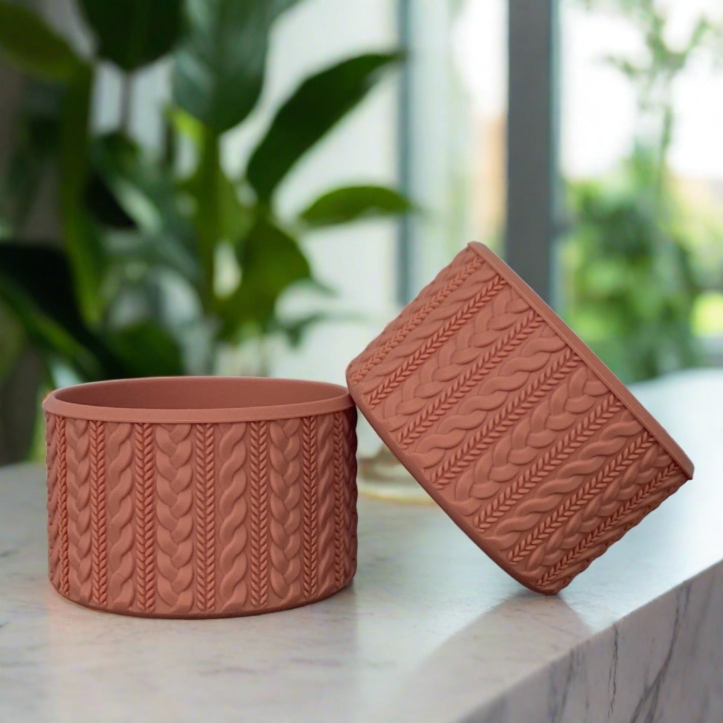 Jordan COZY cable-knit silicone tumbler boot in terracotta by Ecnoy & Company, two boots on a marble counter with greenery behind.